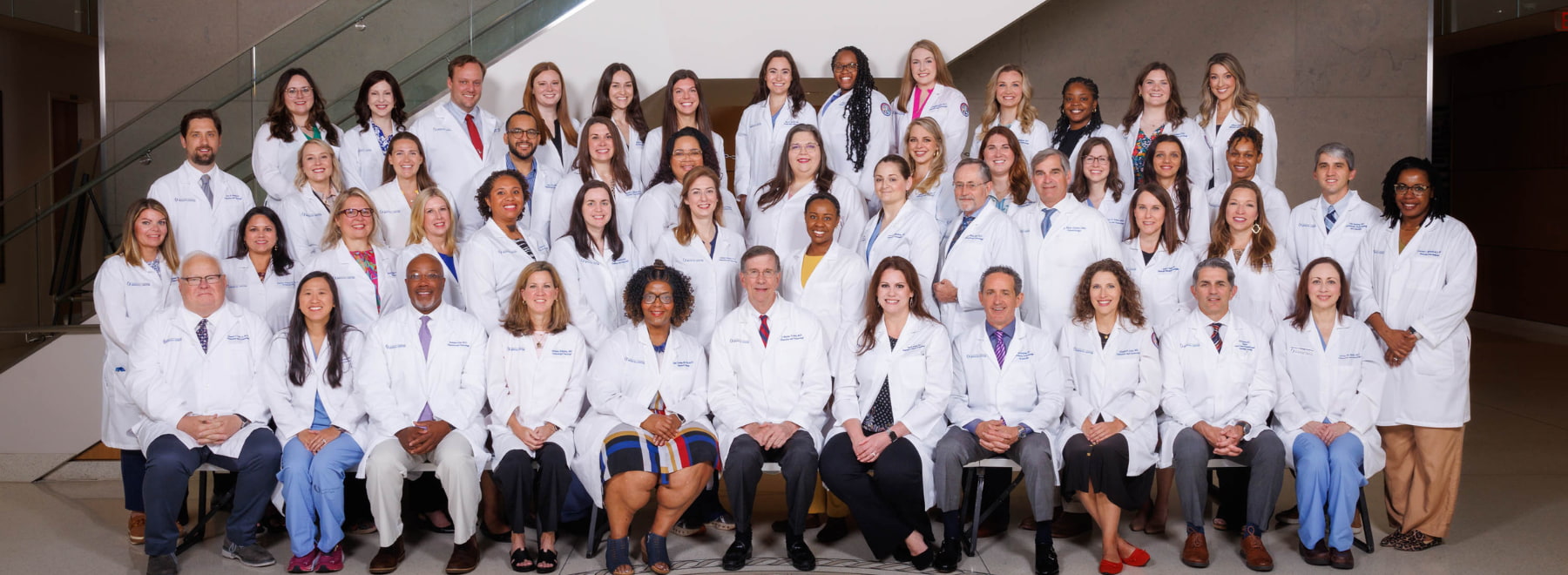 A group photo of the member of Department of Obstetrics and Gynecology poses for a group photo in the lobby of the School of Medicine